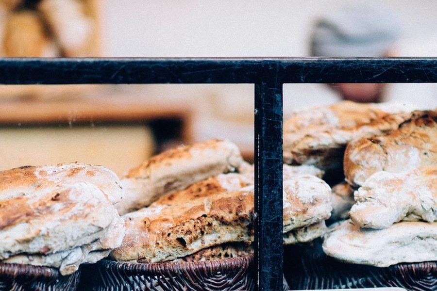Fresh baked goods stacked in a shop display case
